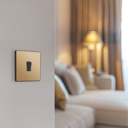 British General Evolve 20A 16AX 1-Gang Intermediate Light Switch Satin Brass with Black Inserts